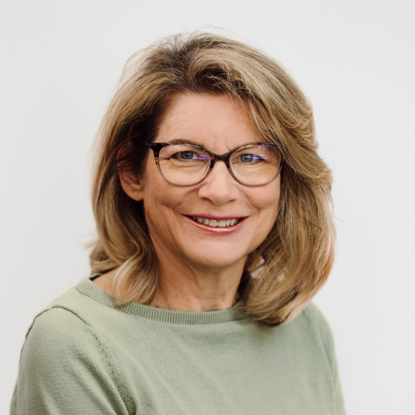 Kathryn Hull woman in dark glasses with a green shirt.