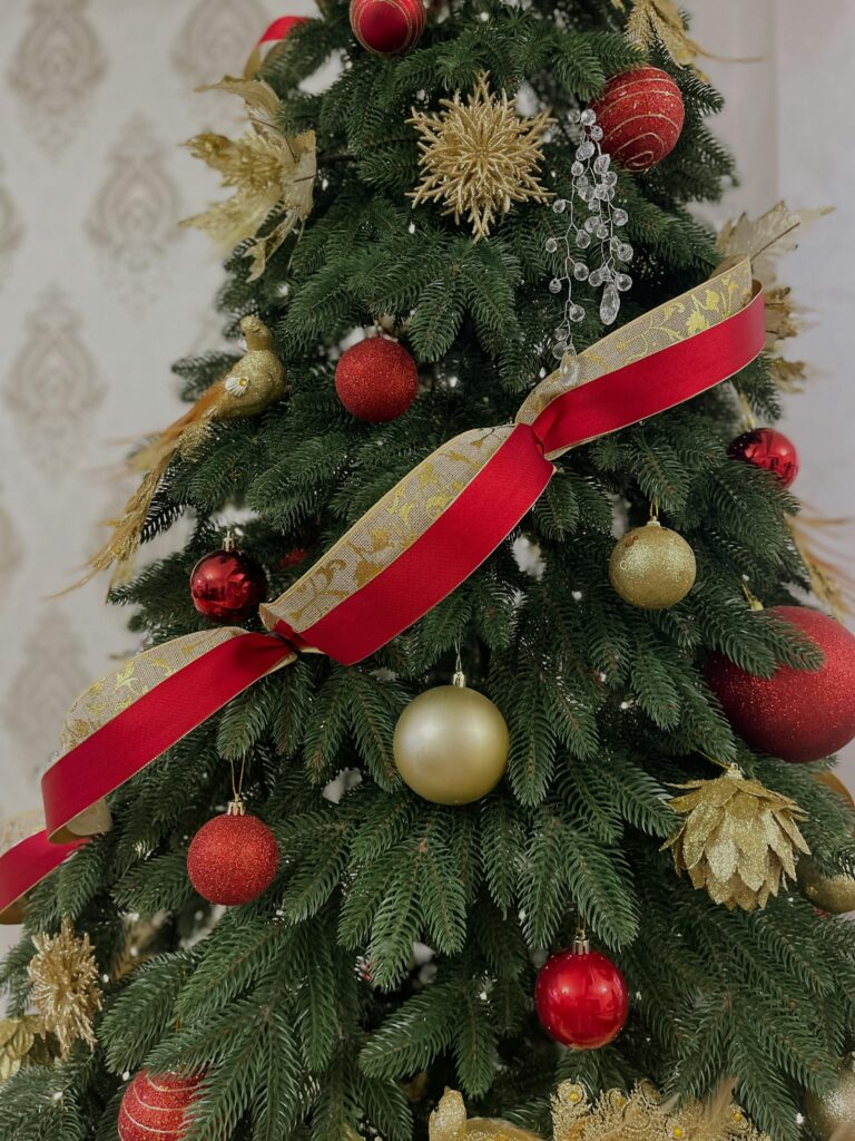 Christmas tree with red and white ornaments as well as ribon