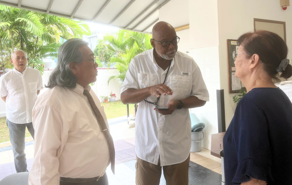 Steven engages in an after-service conversation with ministry leader Henry Lee and Anne Tan.