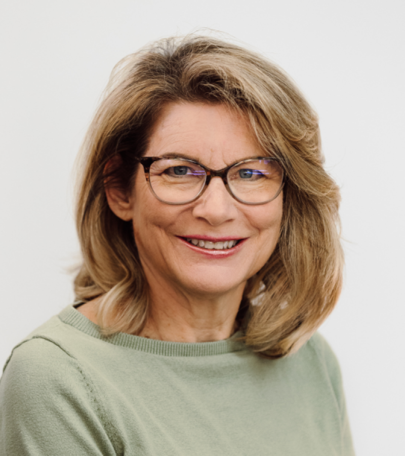 Kathryn Hull woman in dark glasses with a green shirt.