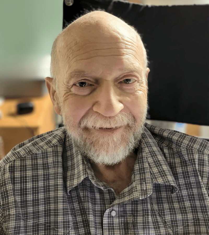 Richard Willowby man smiling with a graying beard and a black & white plaid shirt.